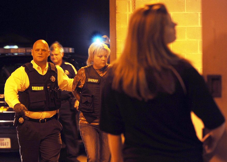 In this photo taken on Tuesday, March 11, 2014, Kristen Westfall is led into the Tyler County Jail by Tyler County Sheriff Bryan Weatherford in Woodville, Texas. Four ex-relatives of have been accused of killing Nathan Bradley Maddox of Zavalla, and his new wife Krystal as he sought custody of his 5-year-old daughter. A grand jury Tuesday, March 11, 2014, indicted Maddox's ex-wife Kristen Westfall, her parents Letha and Paul Westfall, and her brother, Cameron Westfall. Chief Deputy Phil Ryan says the Westfalls are jailed on charges of engaging in organized criminal activity leading to killings during a custody dispute. (AP Photo/The Daily News, Jessica Cooley)