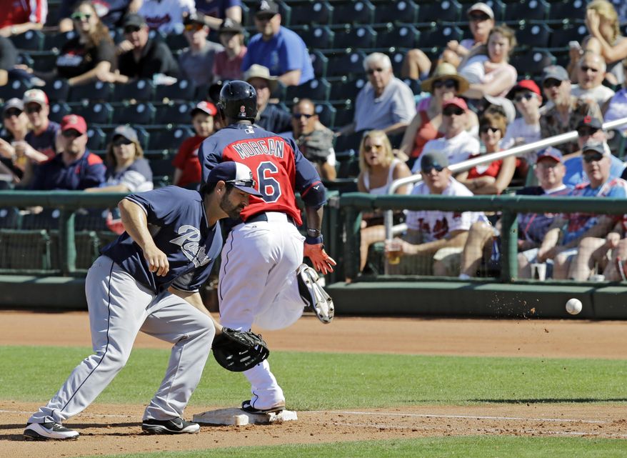 Cleveland Indians' Nyjer Morgan (6) beats the throw to San Diego Padres first baseman Xavier Nady for a bunt single in the fourth inning of a spring exhibition baseball game Wednesday, March 12, 2014, in Goodyear, Ariz. Morgan took second when the ball eluded Nady and rolled into right field. (AP Photo/Mark Duncan)