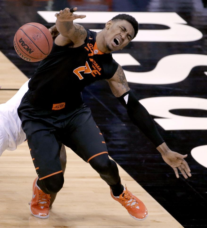 Oklahoma State's Le'Bryan Nash chases a loose ball during the second half of an NCAA college basketball game against Kansas in the Big 12 men's tournament Thursday, March 13, 2014, in Kansas City, Mo. (AP Photo/Charlie Riedel)