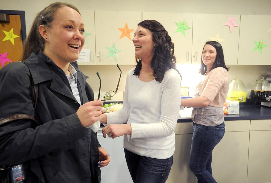 ADVANCE FOR SUNDAY, MARCH 16- In a March 1, 2014 photo, Yvette Vajcner of Newport, left, jokes with her sister Mercedes Toman, center, and friend Jackie Solsburg during a surprise party held at the Frenchtown Branch Library in Frenchtown Township, Mich., to celebrate her 100-pound weight loss. A year ago, Mrs. Vajcner decided to undertake an overhaul to her health, particularly after noticing she was having trouble keeping up with her 3 young children. Through a steady routine of exercise and change in eating habits, she was able to achieve her goal. (AP Photo/Monroe Evening News, Kim Brent)