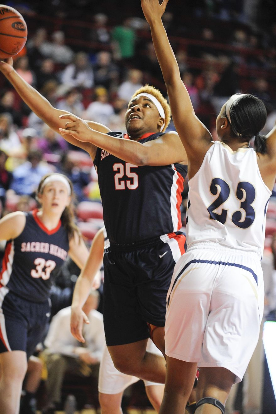 Sacred Heart's DaiJia Ruffin (25) shoots past Elizabethtown's Reauna Cleaver (23) during a first-round game in the KHSAA Girls' Sweet 16 at E.A. Diddle Arena in Bowling Green, Ky., Thursday, March, 13, 2014. Elizabethtown defeated Sacred Heart 76-61. (AP Photo/Daily News, Alex Slitz)