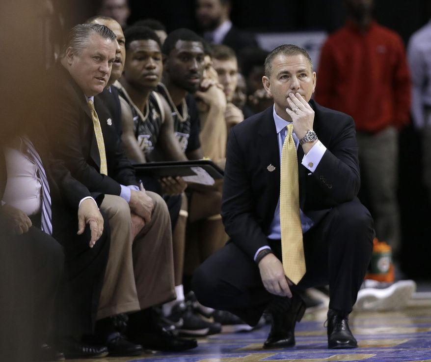 Central Florida coach Donnie Jones, right, watches during the first half of an NCAA college basketball game against Temple at the American Athletic Conference men's tournament Wednesday, March 12, 2014, in Memphis, Tenn. (AP Photo/Mark Humphrey)