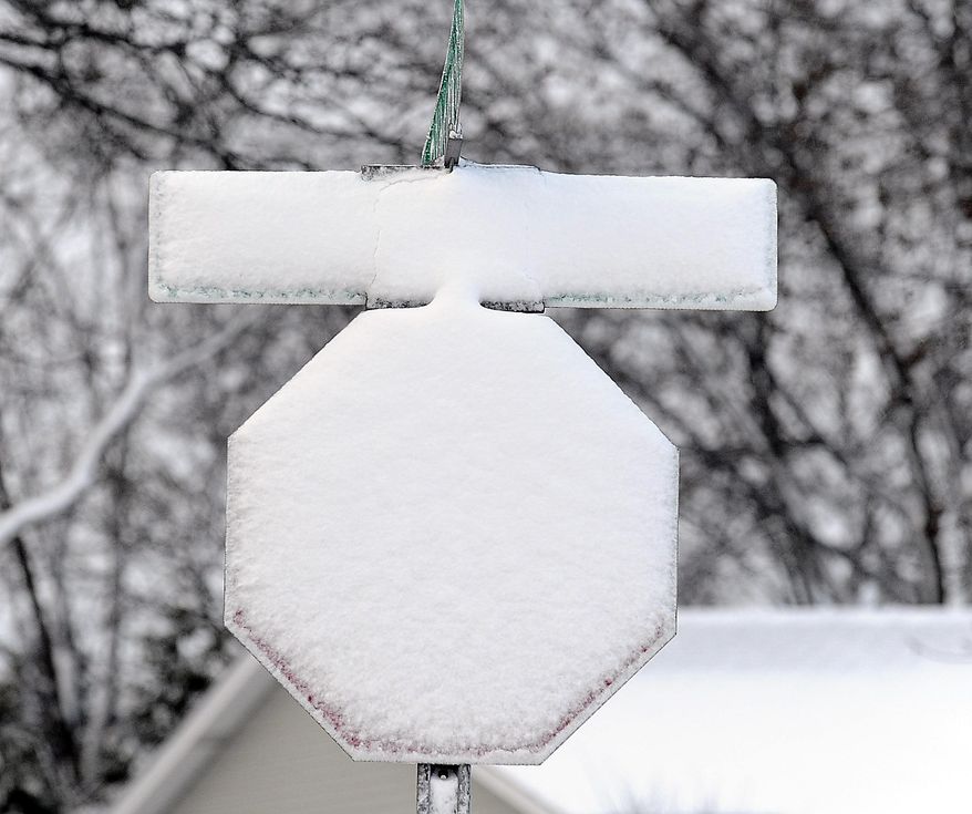 Fresh snow covers a stop sign after a winter storm on Wednesday, March 12, 2014, in Palatine, Ill. ,(AP Photo/Daily Herald, Mark Welsh ) MANDATORY CREDIT, MAGS OUT, TV OUT