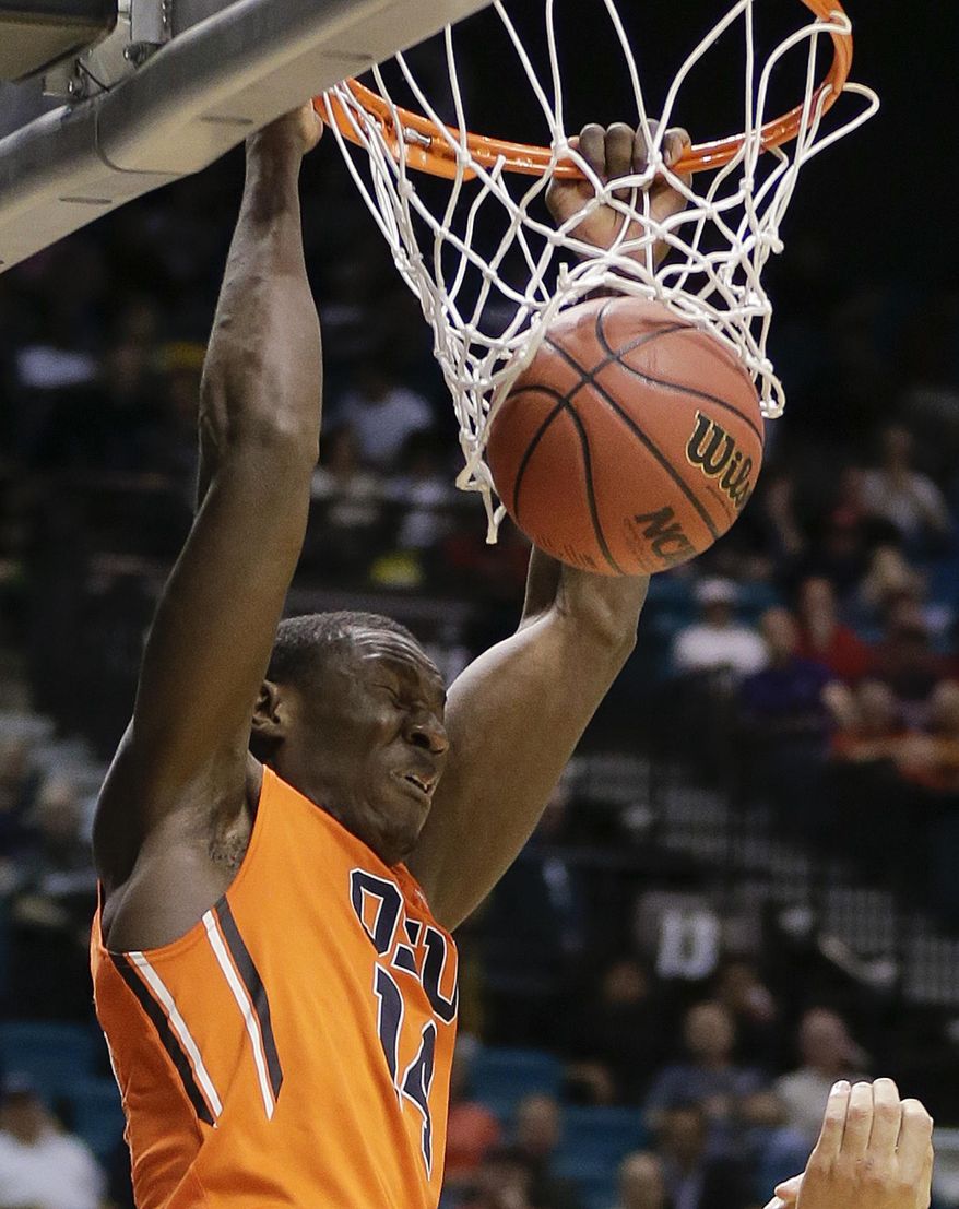 Oregon State's Daniel Gomis dunks against Oregon in the first half of an NCAA college basketball game in the Pac-12 men's tournament, Wednesday, March 12, 2014, in Las Vegas. (AP Photo/Julie Jacobson)