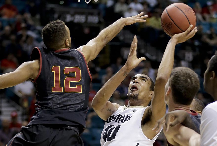 Colorado's Josh Scott shoots against Southern California's Julian Jacobs in the first half of an NCAA college basketball game in the Pac-12 men's tournament, Wednesday, March 12, 2014, in Las Vegas. (AP Photo/Julie Jacobson)