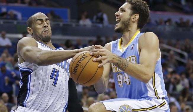 Orlando Magic&#x27;s Arron Afflalo (4) knocks the ball out of the hands of Denver Nuggets&#x27;s Evan Fournier (94) as he goes up for a shot during the first half of an NBA basketball game in Orlando, Fla., Wednesday, March 12, 2014. (AP Photo/John Raoux)