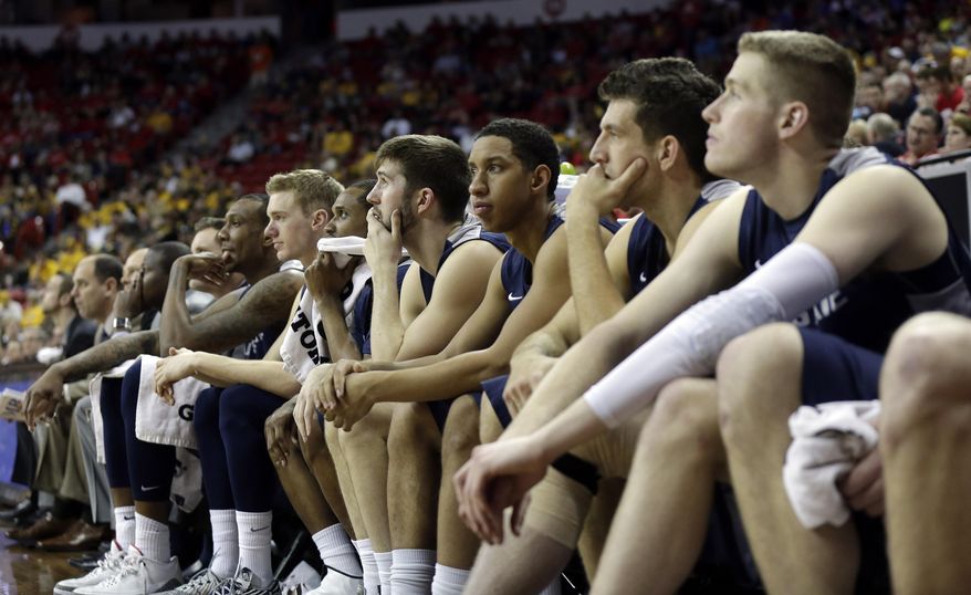 Utah State players watch from bench watches during the final moments of the second half of an NCAA college basketball game in the quarterfinals of the Mountain West Conference tournament Thursday, March 13, 2014, in Las Vegas. San Diego State won 73-39. (AP Photo/Isaac Brekken)