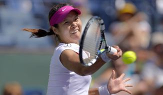 Li Na, of China, hits to Dominika Cibulkova, of Slovakia, during a quarterfinal match at the BNP Paribas Open tennis tournament, Thursday, March 13, 2014 in Indian Wells, Calif. (AP Photo/Mark J. Terrill)