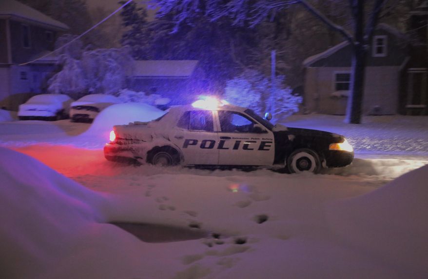 A Kalamazoo public safety police car struggles to get through the heavy wet snow during a winter storm Wednesday, March 12, 2014, in Kalamazoo, Mich. (AP Photo/Kalamazoo Gazette-MLive Media Group, Mark Bugnaski) ALL LOCAL TV OUT; LOCAL TV INTERNET OUT