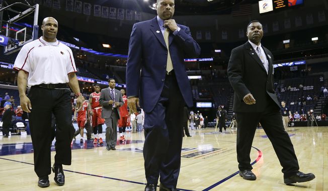 Rutgers head coach Eddie Jordan, center, walks off the court following his team&#x27;s 92-31 loss to Louisville in an NCAA college basketball game in the quarterfinals of the American Athletic Conference tournament Thursday, March 13, 2014, in Memphis, Tenn. (AP Photo/Mark Humphrey)