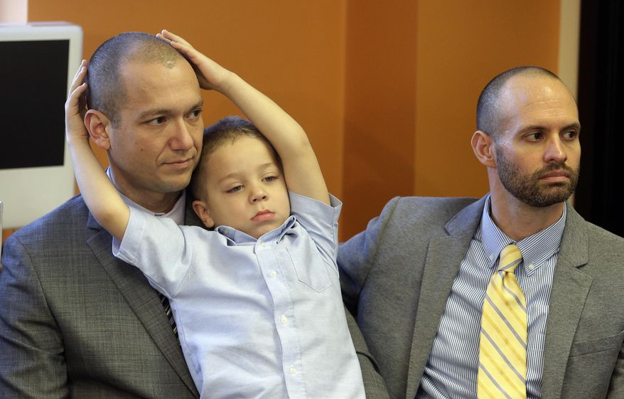FILE - In this Jan. 21, 2014, file photo, plaintiffs Matthew Barraza, left, and his husband Tony Milner, right, look on as their son Jesse, 4, plays, during a news conference in Salt Lake City. A federal judge is set to hear arguments Wednesday morning, March 12, 2014, from four same-sex couples suing Utah over its decision to stop granting benefits to newly married gay couples. The American Civil Liberties Union filed the lawsuit in January saying the state's decision violates the couple's vested rights. (AP Photo/Rick Bowmer, File)