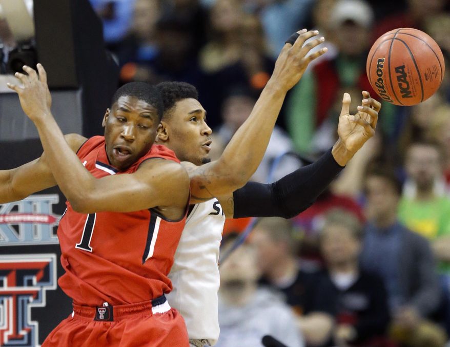 Oklahoma State forward Le'Bryan Nash,right, rebounds against Texas Tech guard Randy Onwuasor (1) during the first half of an NCAA college basketball game in the Big 12 men's tournament in Kansas City, Mo., Wednesday, March 12, 2014. (AP Photo/Orlin Wagner)