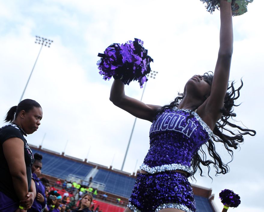 ADVANCE FOR RELEASE MONDAY, MARCH 17, 2014, AND THEREAFTER - In this Saturday, April 27, 2013 photo, Raven Carrington, a majorette at Lincoln High School, performs with the band for the hundreds of kids attending a celebration event at SMU's Ford Stadium, in Dallas, for the Imagine 2020 initiative, which focuses on inspiring students despite obstacles through engagement, education, and various resources. The multi-million dollar initiative that targets struggling Dallas Independent School District campuses has taken off, and some principals say it's paying off. (AP Photo/The Dallas Morning News, Mona Reeder) MANDATORY CREDIT; MAGS OUT; TV OUT; INTERNET USE BY AP MEMBERS ONLY; NO SALES