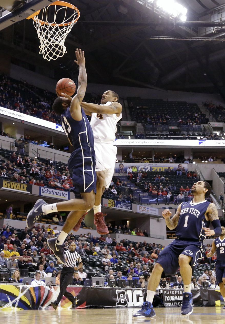 Minnesota guard Deandre Mathieu (4) takes a shot against Penn State guard Geno Thorpe (13) as Penn State's John Johnson (1) looks on in the first half of an NCAA college basketball game in the first round of the Big Ten Conference tournament, Thursday, March 13, 2014, in Indianapolis. (AP Photo/Michael Conroy)