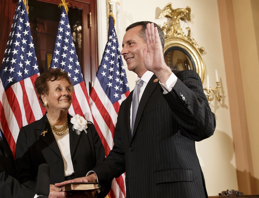 Newly elected Republican Rep. David Jolly of Florida, right, poses for a ceremonial swearing-in with his mother Judy Jolly and House Speaker John Boehner of Ohio, on Capitol Hill in Washington, Thursday, March 13, 2014. Earlier this week, Jolly edged out Democrat Alex Sink in a special election that Republicans cast as a referendum on President Barack Obama and his unpopular health care law. The Tampa-area district had been considered a toss-up. Jolly fills the open seat that had been held for decades by Republican C.W. Bill Young who died in October. The 41-year-old Jolly has long experience in Washington, first as an aide to Young and then as a lobbyist. Republicans now hold 233 seats in the House to the Democrats’ 199. There are three vacancies. (AP Photo/J. Scott Applewhite)