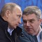 In this photo taken Saturday, March 8, 2014, Russian President Vladimir Putin, left, and International Olympic Committee President Thomas Bach speak during the ice sledge hockey match between Russia and South Korea of the 2014 Winter Paralympics in Sochi, Russia. (AP Photo/RIA-Novosti, Alexei Nikolsky, Presidential Press Service)