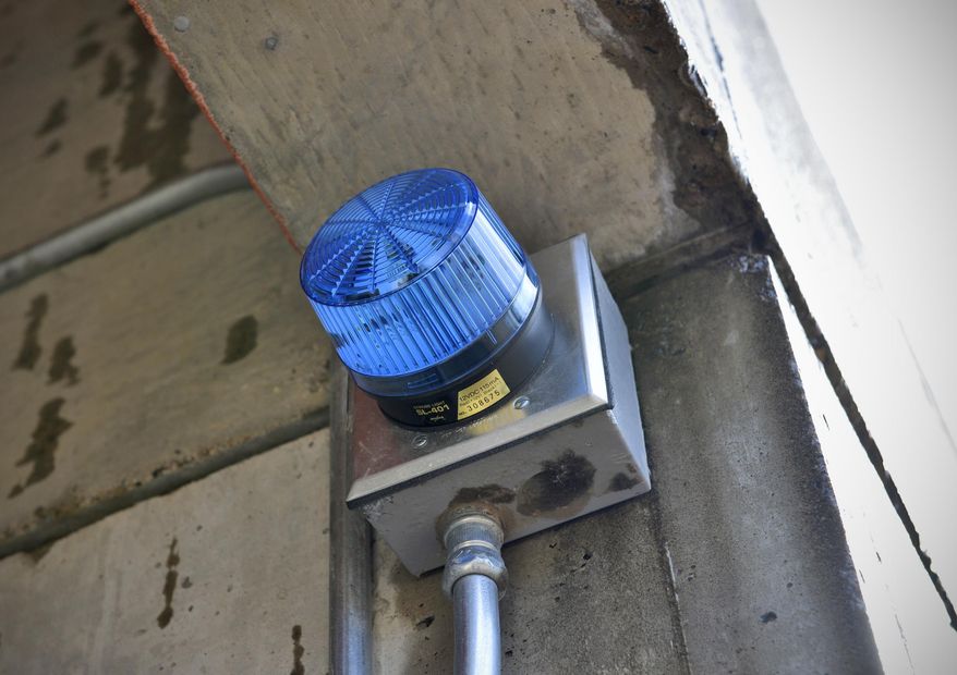 In this March 11, 2014 photo, blue strobe lights is shown at Apollo High School in St. Cloud, Minn. Blue lights newly installed at every entrance are meant to prevent more people from entering the building. The light indicates a lockdown at the school. (AP Photo/St. Cloud Times, Kimm Anderson)