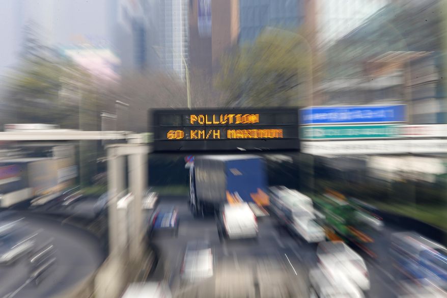 An electronic road sign on the Paris ring road reads "Pollution" Friday March 14, 2014. Air pollution that has turned Paris skies a murky yellow is giving a break to millions of French travelers — all public transportation in the Paris region and two other cities is free for the next three days. Nearly three-quarters of France is under alert in what the European Environment Agency says is the worst air pollution since 2007. (AP Photo/Jacques Brinon)