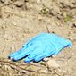 A forensic glove is located in the crime scene after a U.S. Border Patrol kidnapped and assaulted three immigrants from Honduras Thursday March 13, 2014, in Mission, Texas. Esteban Manzanares shot himself in the head killing himself before FBI agents entered his apartment. (AP Photo/The Monitor, Gabe Hernandez)