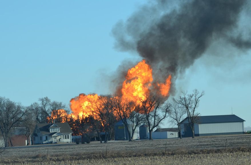 Flames leap into the air from a natural gas pipeline fire on Friday, March 14, 2014 north of Fremont. The line erupted about 8:30 a.m. Friday near the intersection of county roads 20 and O, about six miles north of Fremont. No damage to any structures has been reported. Firefighters from four departments were waiting nearby for workers to turn off the gas flow. The flames towered dozens of feet into the sky, and the heat kept firefighters from getting close enough to see what caused the blast. (AP Photo/The Tribune, Chris Zavadil)