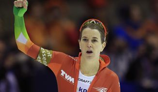 Ireen Wust of the Netherlands celebrates winning the women&#x27;s 1500-meter speedskating race of the World Cup final at Thialf skating arena in Heerenveen, northern Netherlands, Friday, March 14, 2014. (AP Photo/Peter Dejong)