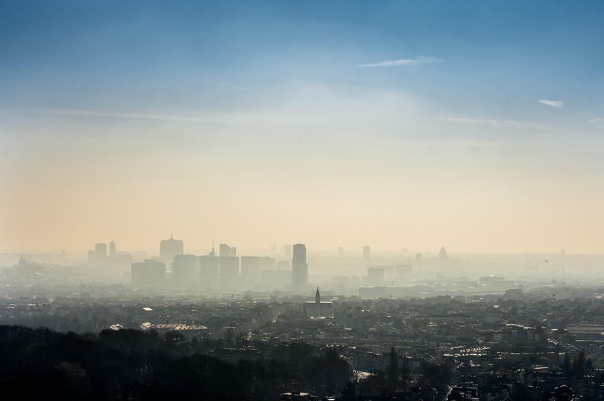 A layer of smog covers the city of Brussels on Friday March 14, 2014. The INRIX traffic scorecard rated Belgium as the most congested country in the world with the Belgian cities of Antwerp and Brussels the most congested. The INRIX Traffic Scorecard provides a comprehensive analysis of the state of traffic congestion across the world. With more than 300,000 cars entering Brussels everyday and an average of 85,4 hours of traffic jams per car per year, road traffic is one of the main sources of air pollution in Brussels. As a result of the Smog alert maximum speed on the motorway has been cut to 90km/h (55mph). (AP Photo/Geert Vanden Wijngaert)