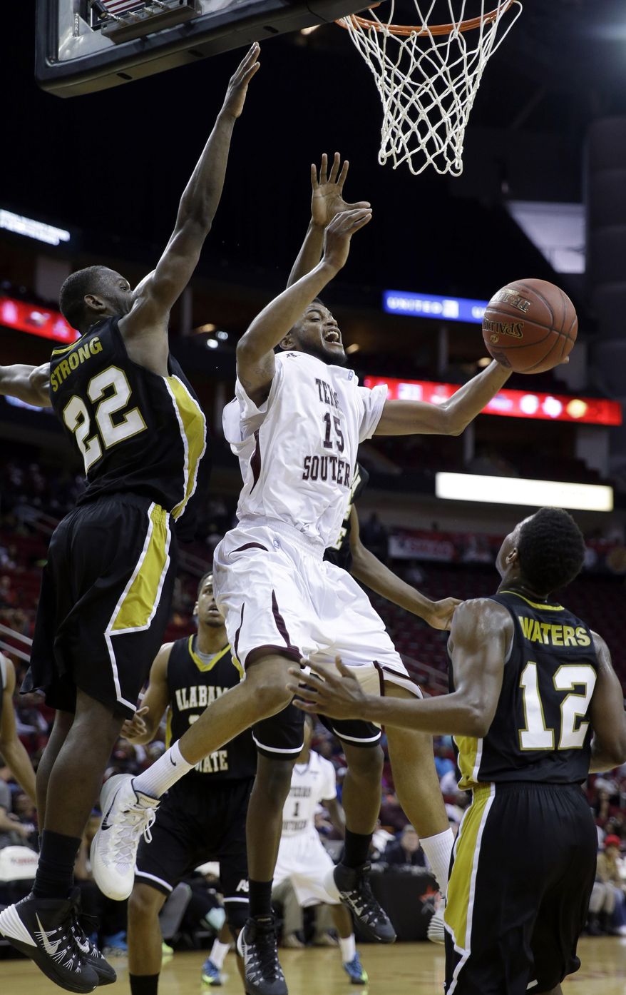 Texas Southern's D'Angelo Scott (15) shoots as Alabama State's Maurice Strong (22) and Jamel Waters (12) defend during the first half of an NCAA college basketball game in the semifinals of the Southwestern Athletic Conference tournament Friday, March 14, 2014, in Houston. Texas (AP Photo/David J. Phillip)