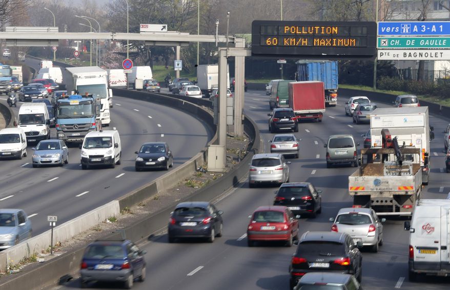 An electronic road sign reads "Pollution" on the Paris ring road, Friday March 14, 2014. Air pollution that has turned Paris skies a murky yellow is giving a break to millions of French travelers — all public transportation in the Paris region and two other cities is free for the next three days. Nearly three-quarters of France is under alert in what the European Environment Agency says is the worst air pollution since 2007. (AP Photo/Jacques Brinon)