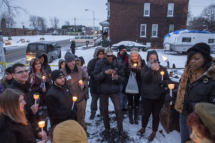 Jenenne Whitfield, Heidelberg Project director, addresses attendees during a vigil at the site of the latest fire at the Heidelberg Project in Detroit, Thursday, March 13, 2014. A March 7 fire destroyed a house covered in stuffed animals and dolls that was part of the Heidelberg Project. It was the latest casualty in a 10-month string of suspicious fires at houses that are part of the interactive outdoor art installation. Tyree Guyton founded the Heidelberg Project on Detroit's east side in 1986 as a response to urban decay. (AP Photo/The Saginaw News, Katie Bailey) ALL LOCAL TV OUT; LOCAL TV INTERNET OUT