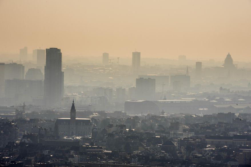 A layer of smog covers the city of Brussels on Friday March 14, 2014. The INRIX traffic scorecard rated Belgium as the most congested country in the world with the Belgian cities of Antwerp and Brussels the most congested. The INRIX Traffic Scorecard provides a comprehensive analysis of the state of traffic congestion across the world. With more than 300,000 cars entering Brussels everyday and an average of 85,4 hours of traffic jams per car per year, road traffic is one of the main sources of air pollution in Brussels. As a result of the Smog alert maximum speed on the motorway has been cut to 90km/h (55mph). (AP Photo/Geert Vanden Wijngaert)