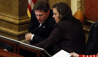 Rep. Jim Dunnigan, R-Taylorsville and House Speaker Becky Lockhart, R-Provo talks before he becomes Speaker pro tem at the Capitol in Salt Lake City, Thursday, March 13, 2014. (AP Photo/The Deseret News, Ravell Call)