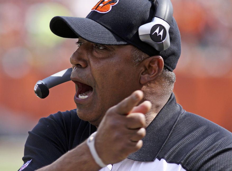 FILE - In this Sept. 25, 2011, file photo, Cincinnati Bengals head coach Marvin Lewis urges on his players during the first half of an NFL football game against the San Francisco 49ers in Cincinnati. Lewis signed a one-year contract extension Friday, March 14, 2014, keeping him on the job through the 2015 season. (AP Photo/Tom Uhlman, File)