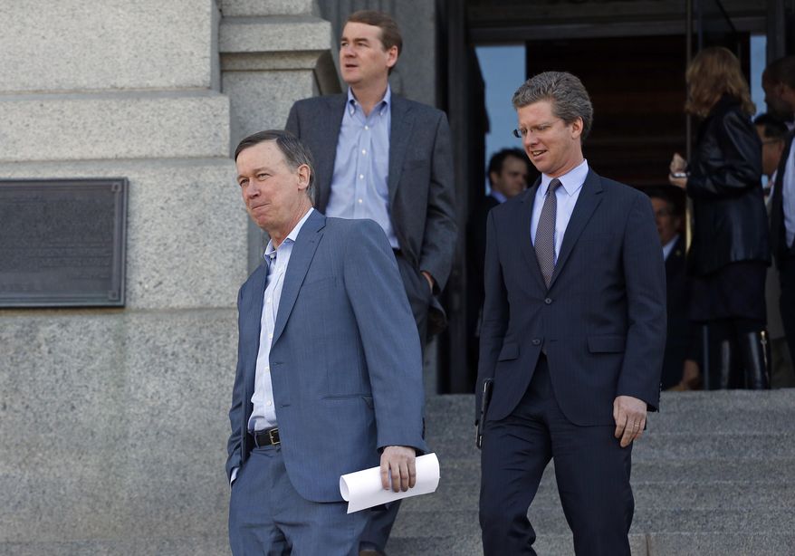 Colo. Gov. John Hickenlooper, left, walks down the state Capitol steps with Secretary of U.S. Housing and Urban Development (HUD) Shaun Donovan, right, and U.S. Senator Michael Bennet, in Denver, Friday, March 14, 2014. Secretary Donovan announced Friday that Colorado is getting an additional $199 million from the federal government to help communities devastated by September's historic floods. (AP Photo/Brennan Linsley)