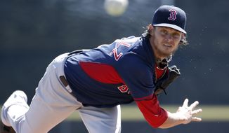 Boston Red Sox starting pitcher Clay Buchholz delivers a warm-up pitch before the start of a spring exhibition baseball game against the Toronto Blue Jays in Dunedin, Fla., Friday, March 14, 2014.  Buchholz allowed no runs on two hits with three strikeouts in four innings. (AP Photo/Kathy Willens)