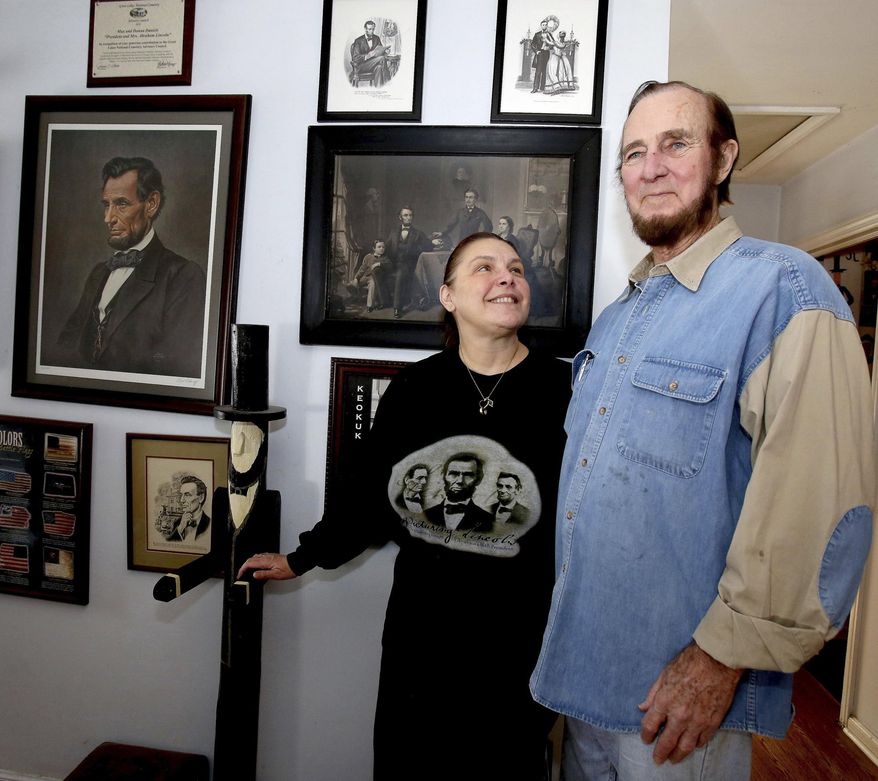 In this Feb. 3, 2014 photo, Max and Donna Daniels, of Wheaton, Ill., are seen at home next to a wall of Abraham Lincoln portraits. What started as small roles in community theater has evolved into a full-time occupation portraying President and Mrs. Lincoln. They began portraying our 16th president and his wife in 1987 and haven’t stopped since.  (AP Photo/Daily Herald, Bev Horne)  MANDATORY CREDIT, MAGS OUT
