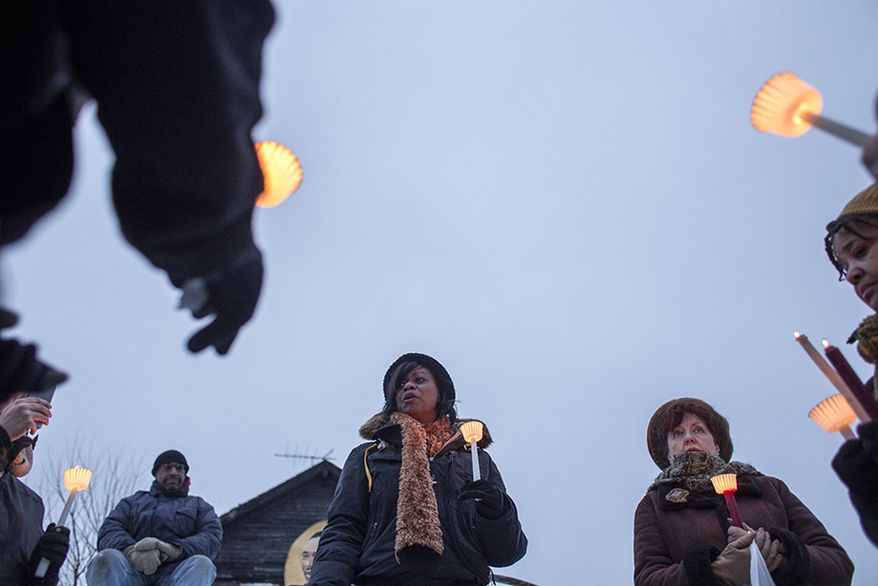Jenenne Whitfield, Heidelberg Project director, addresses attendees at a vigil at the site of the latest fire at the Heidelberg Project in Detroit, Thursday, March 13, 2014. A March 7 fire destroyed a house covered in stuffed animals and dolls that was part of the Heidelberg Project. It was the latest casualty in a 10-month string of suspicious fires at houses that are part of the interactive outdoor art installation. Tyree Guyton founded the Heidelberg Project on Detroit's east side in 1986 as a response to urban decay. (AP Photo/The Saginaw News, Katie Bailey) ALL LOCAL TV OUT; LOCAL TV INTERNET OUT