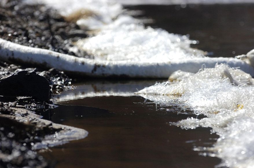 Material meant to contain spilled crude oil lines the side of a railroad bed in a swamp near Aliceville, Ala., on Wednesday, March 5, 2014. A train carrying nearly 3 million gallons of oil derailed and burned at the site in November 2013, resulting in the pollution. Environmental regultors say cleanup and containment work is continuing, but critics contend the Alabama accident and others show the danger of transporting large amounts of oil in tanker trains. (AP Photo/Jay Reeves)