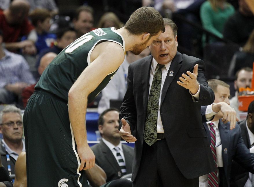 Michigan State head coach Tom Izzo, right, talks to forward Matt Costello in the first half of an NCAA college basketball game against Wisconsin in the semifinals of the Big Ten Conference tournament Saturday, March 15, 2014, in Indianapolis. (AP Photo/Kiichiro Sato)