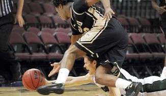 Idaho&#x27;s Mike Scott, left, and Utah Valley&#x27;s Holton Hunsaker chase a loose ball during the second half of an NCAA college men&#x27;s basketball game in the semifinals of the West Athletic Conference tournament Friday, March 14, 2014, in Las Vegas. Idaho won 74-69. (AP Photo/David Becker)