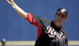Cincinnati Reds&#x27; Brett Marshall throws before the first inning of an exhibition spring baseball game against the Milwaukee Brewers, Saturday, March 15, 2014, in Phoenix. (AP Photo/Morry Gash)