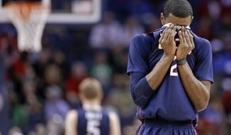 Connecticut forward DeAndre Daniels (2) wipes his face during the second half of an NCAA college basketball game against Louisville in the final of the American Athletic Conference men&#39;s tournament Saturday, March 15, 2014, in Memphis, Tenn. Louisville won 71-61. (AP Photo/Mark Humphrey)