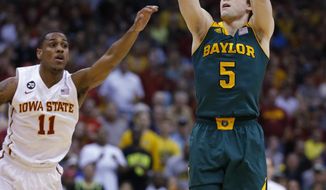 Baylor guard Brady Heslip (5) shoots a 3-point basket as Iowa State guard Monte Morris (11) defends during the first half of an NCAA college basketball game in the final of the Big 12 Conference men&#39;s tournament in Kansas City, Mo., Saturday, March 15, 2014. (AP Photo/Orlin Wagner)