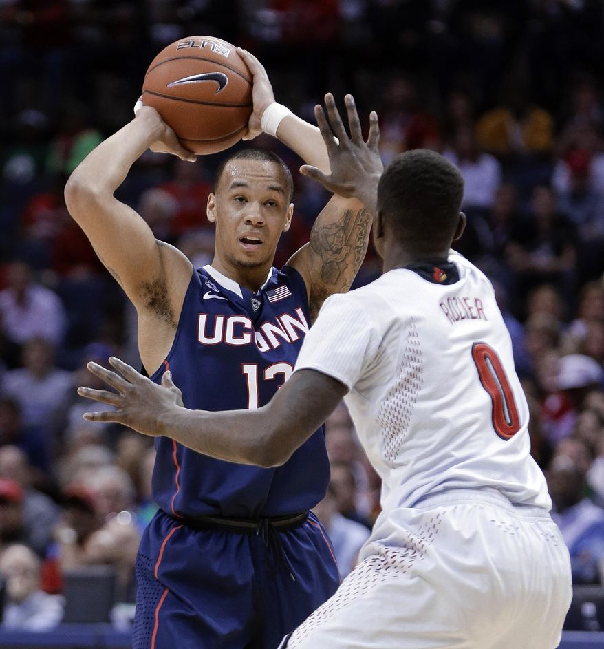 Connecticut guard Shabazz Napier (13) looks for a way around Louisville guard Terry Rozier (0) during the first half of an NCAA college basketball game in the finals of the American Athletic Conference men's tournament Saturday, March 15, 2014, in Memphis, Tenn. (AP Photo/Mark Humphrey)