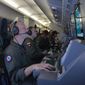 In this photo provided by the U.S. Navy, crew members on board an aircraft P-8A Poseidon assist in search-and-rescue operations for Malaysia Airlines flight MH370 in the Indian Ocean on March 16, 2014. (Associated Press)