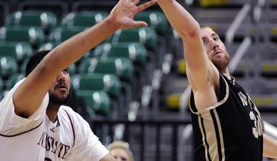 Idaho&#x27;s Stephen Madison, right, steals a pass to New Mexico State&#x27;s Sim Bhullar during the first half of an NCAA college basketball game in the championship of the Western Athletic Conference men&#x27;s tournament Saturday, March 15, 2014, in Las Vegas. (AP Photo/David Becker)