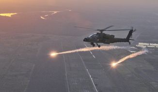 In this photo released by the U.S Army National Guard shows an AH-64D Apache Longbow with the South Carolina Army National Guard releasing flares during a test over Camp Tajo, Iraq, October 8, 2011. A Pentagon budget plan to strip the Army National Guard’s Apache attack helicopters from America’s citizen-soldiers doesn’t sit well with the newly-retired South Carolina National Guard general who commanded a chopper battalion and flew them for more than 1,500 hours. (AP Photo/U.S. Army National Guard, Tracci Dorgan)