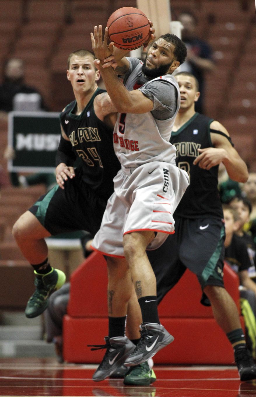 Cal State Northridge forward J.J. Thomas, center, battles for a loose ball with Cal Poly forward Brian Bennett, left and forward Chris Eversley, right, in the second half of the NCAA Big West tournament championship college basketball game in Anaheim, Calif., Saturday, March 15, 2014. Cal Poly won 61-59. (AP Photo/Alex Gallardo)