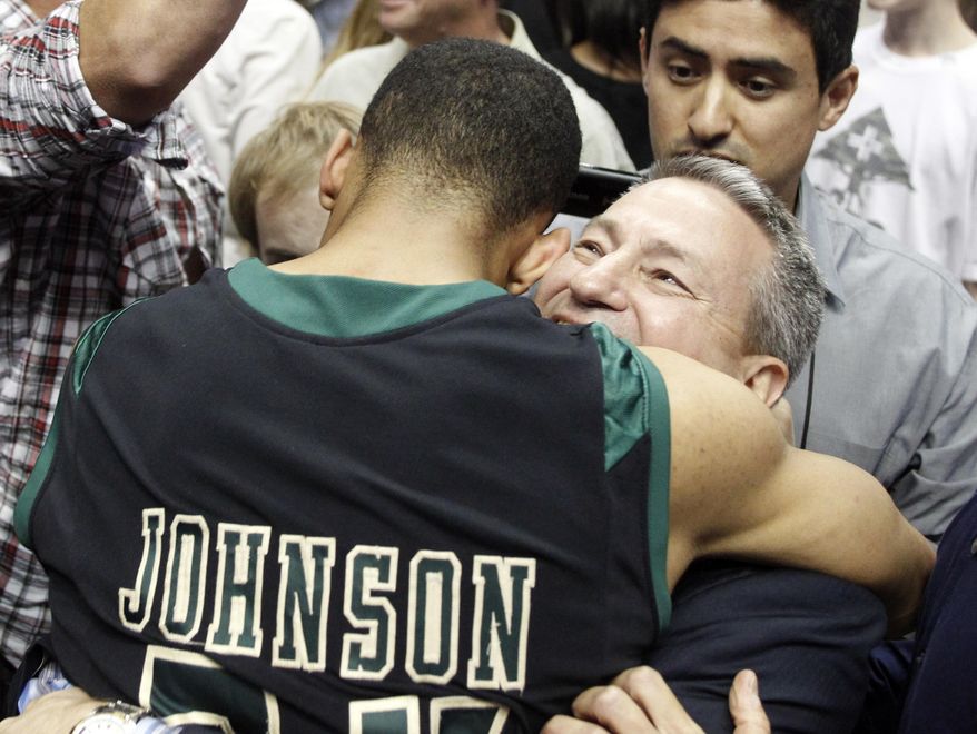 Cal Poly head coach Joe Callero, right, celebrates with Cal Poly guard Jamal Johnson after defeating Cal State Northridge 61-59 in the NCAA Big West tournament championship college basketball game in Anaheim, Calif., Saturday, March 15, 2014. Cal Poly won 61-59. (AP Photo/Alex Gallardo)