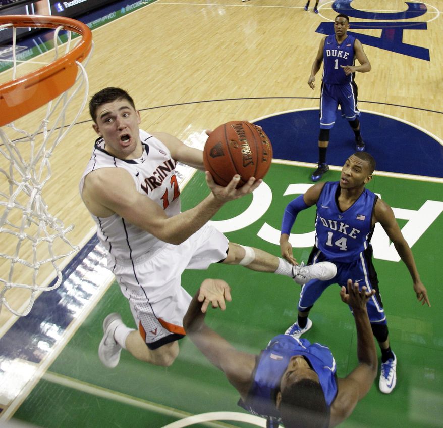 Virginia's Joe Harris (12) goes to the basket against Duke in the second half of an NCAA college basketball game in the championship of the Atlantic Coast Conference tournament in Greensboro, N.C., Sunday, March 16, 2014. Virginia won 72-63. Harris was the tournament MVP. (AP Photo/Bob Leverone)