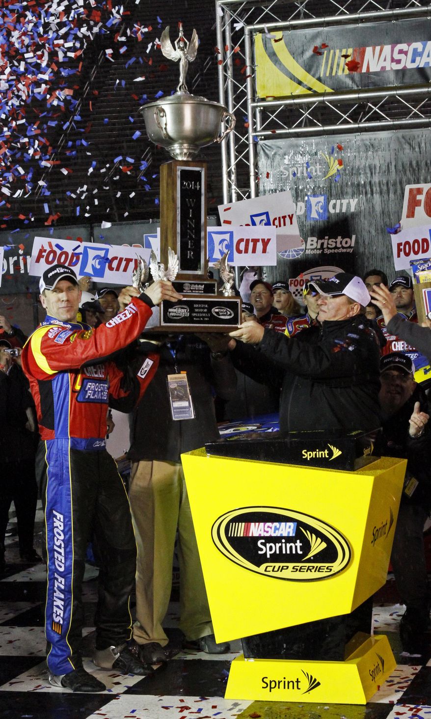 Driver Carl Edwards (99) celebrates in victory lane with his trophy after winning the NASCAR Sprint Cup series auto race at Bristol Motor Speedway, Sunday, March 16, 2014, in Bristol, Tenn. (AP Photo/Wade Payne)
